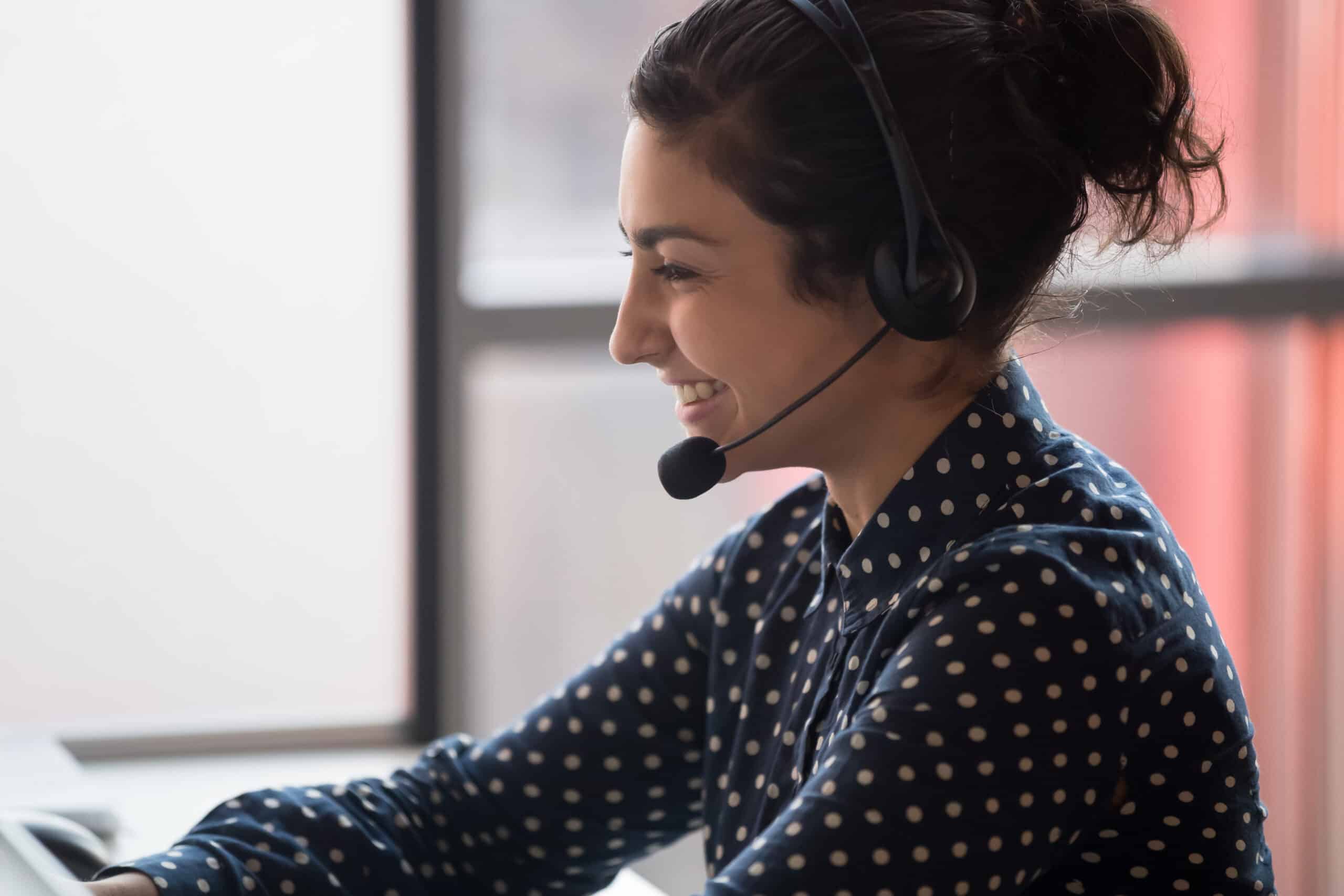Millennial happy indian call center worker consulting client.